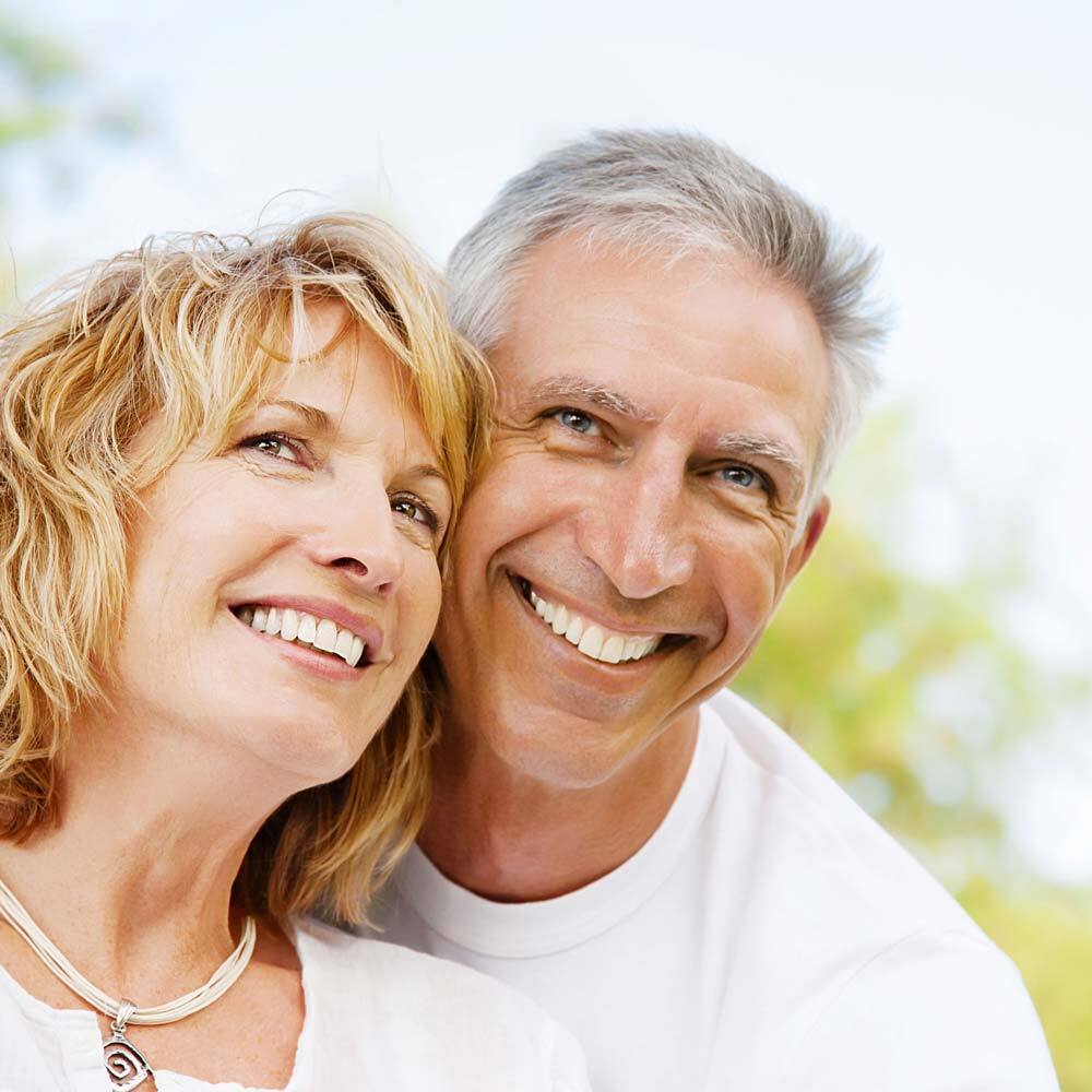 Portrait of Smiling Mature Senior Couple After Visiting One Eleven Dental Care