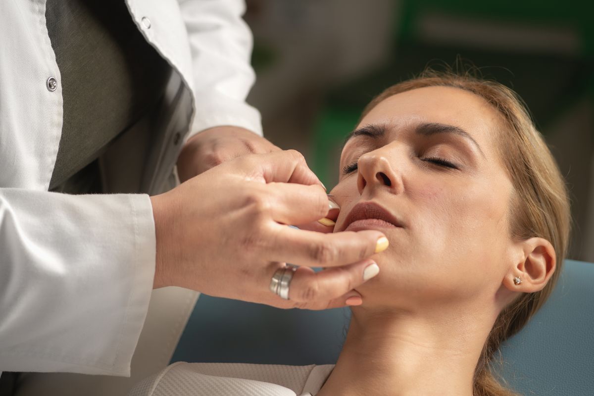 Dentist examining patient's mouth during TMJ evaluation at Bixby dental office.