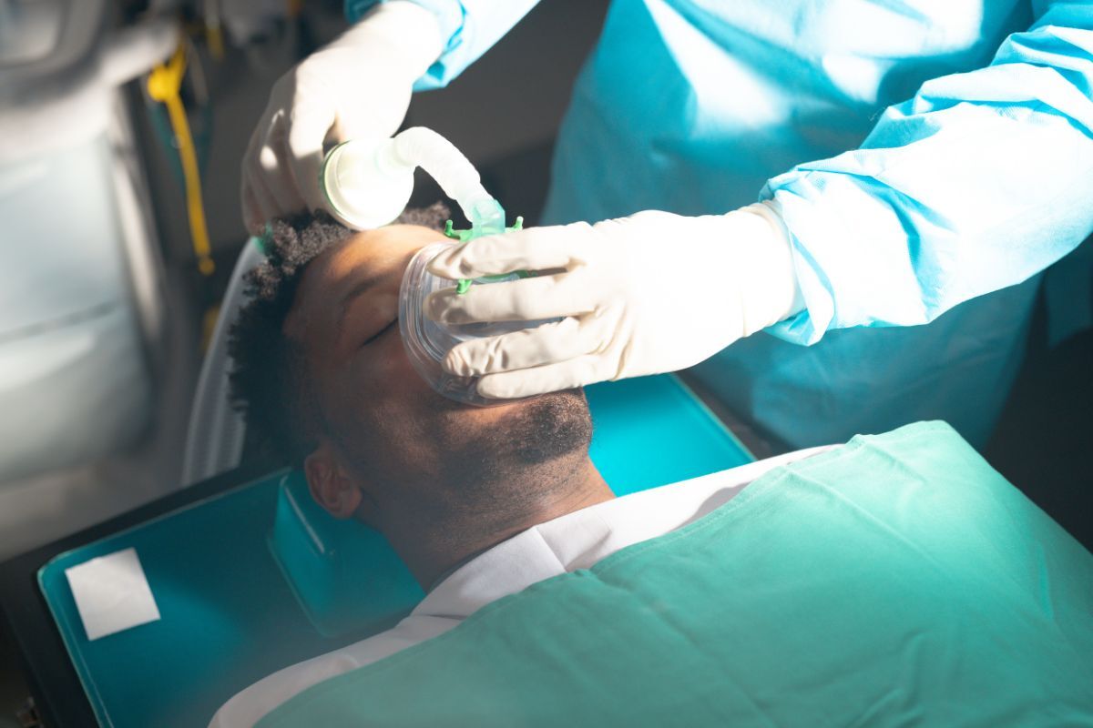 How Does Sedation Dentistry Work Dentist performing sedation dentistry procedure on patient in Bixby dental office.