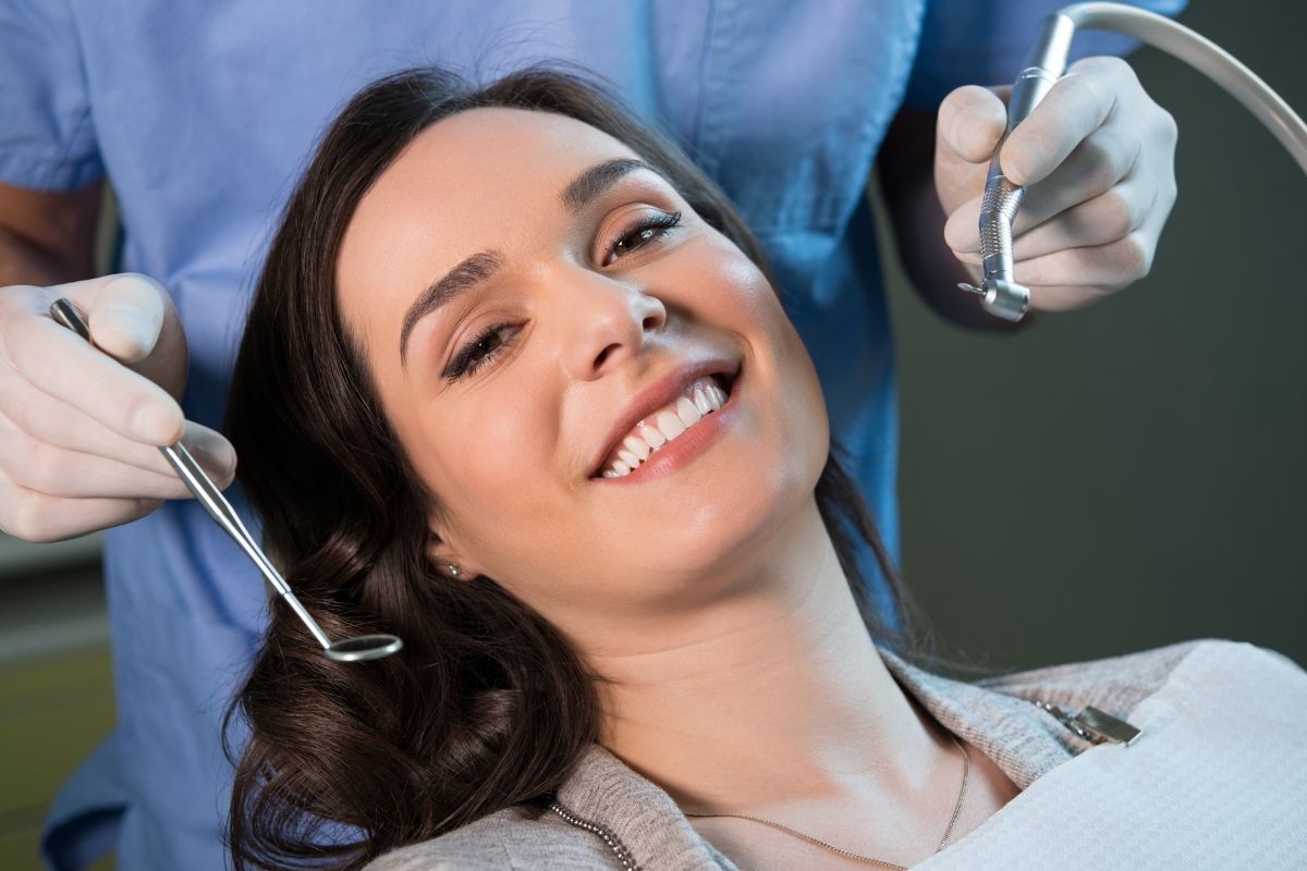 Schedule Dental Checkups Smiling patient receiving dental checkup from dentist in Bixby.