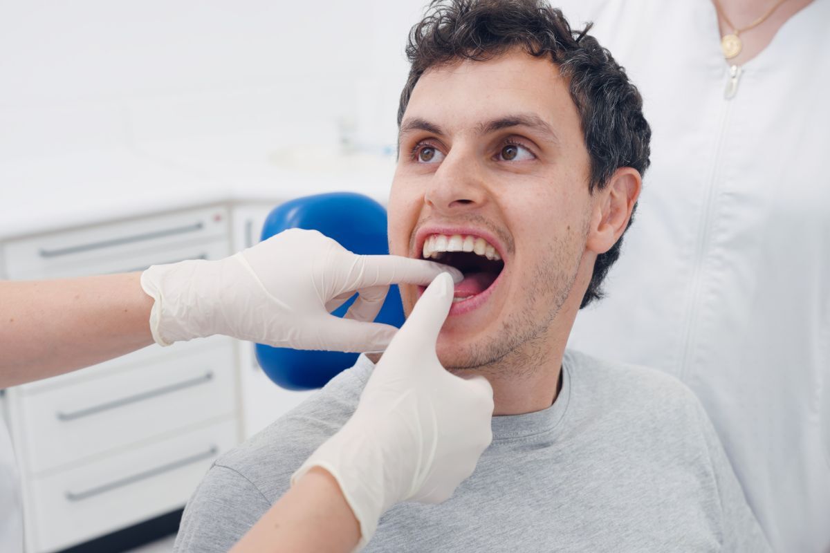 Why Routine Dental Care Matters More Than You Think Dentist examining patient's teeth during routine dental checkup in Bixby office.